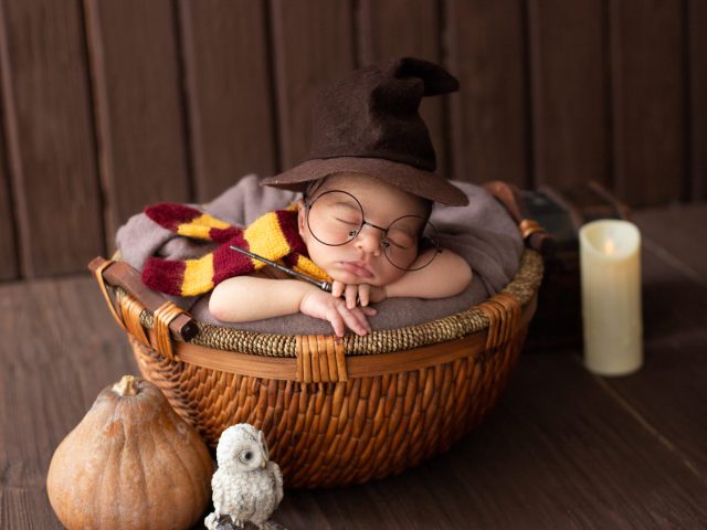 baby-boy-laying-inside-little-basket-with-funny-wizard-costume