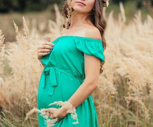 The future mother stands in the field