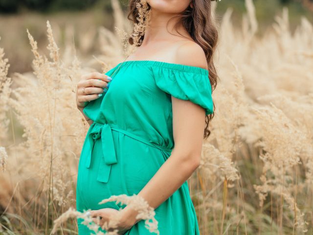 The future mother stands in the field