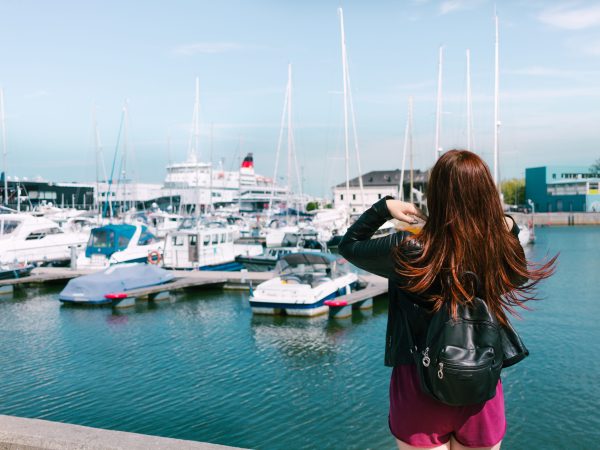 rear-view-woman-standing-harbor