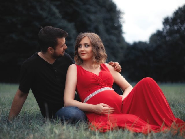 young-couple-sitting-field